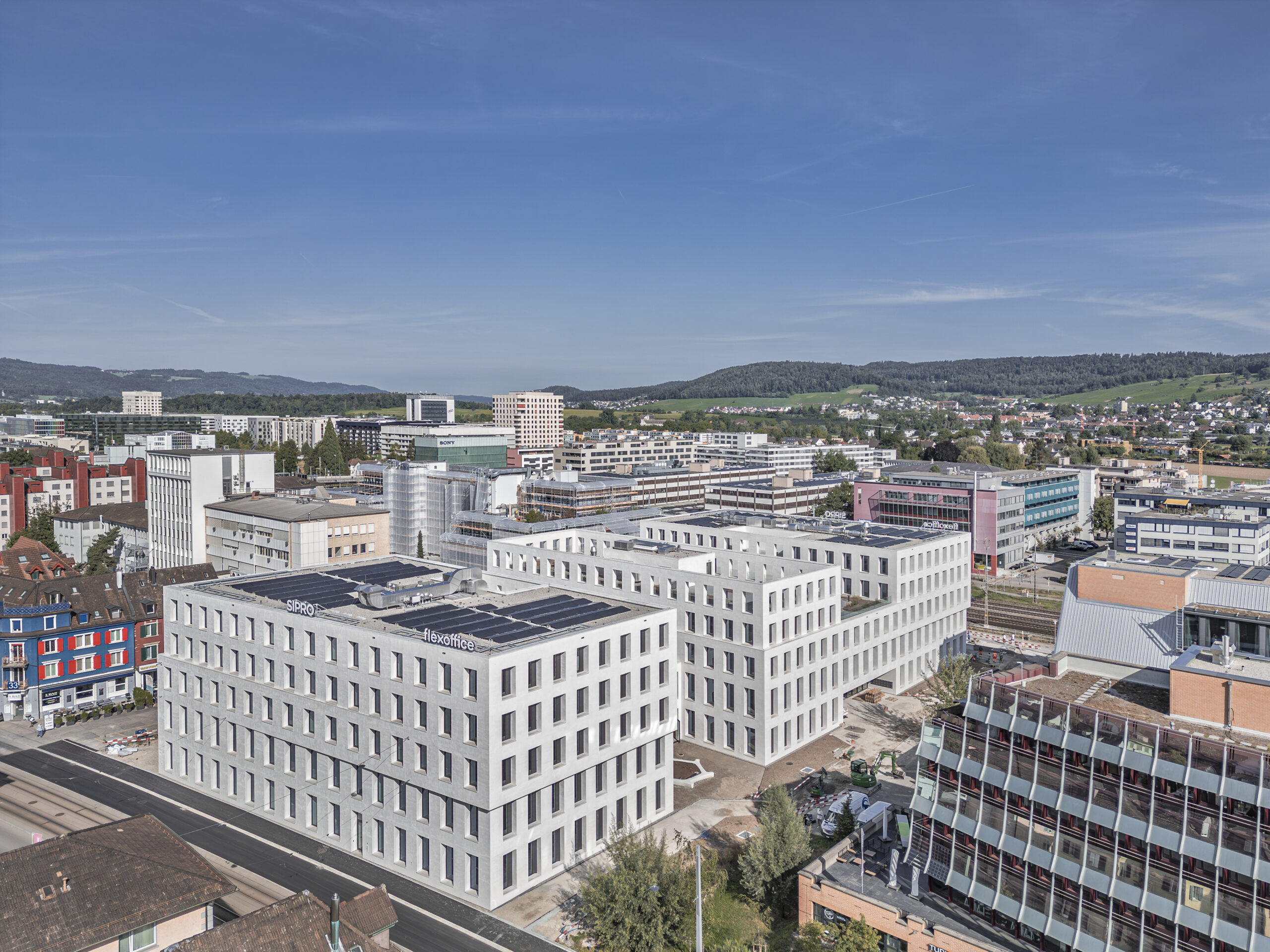 office building with many windows mountains in background