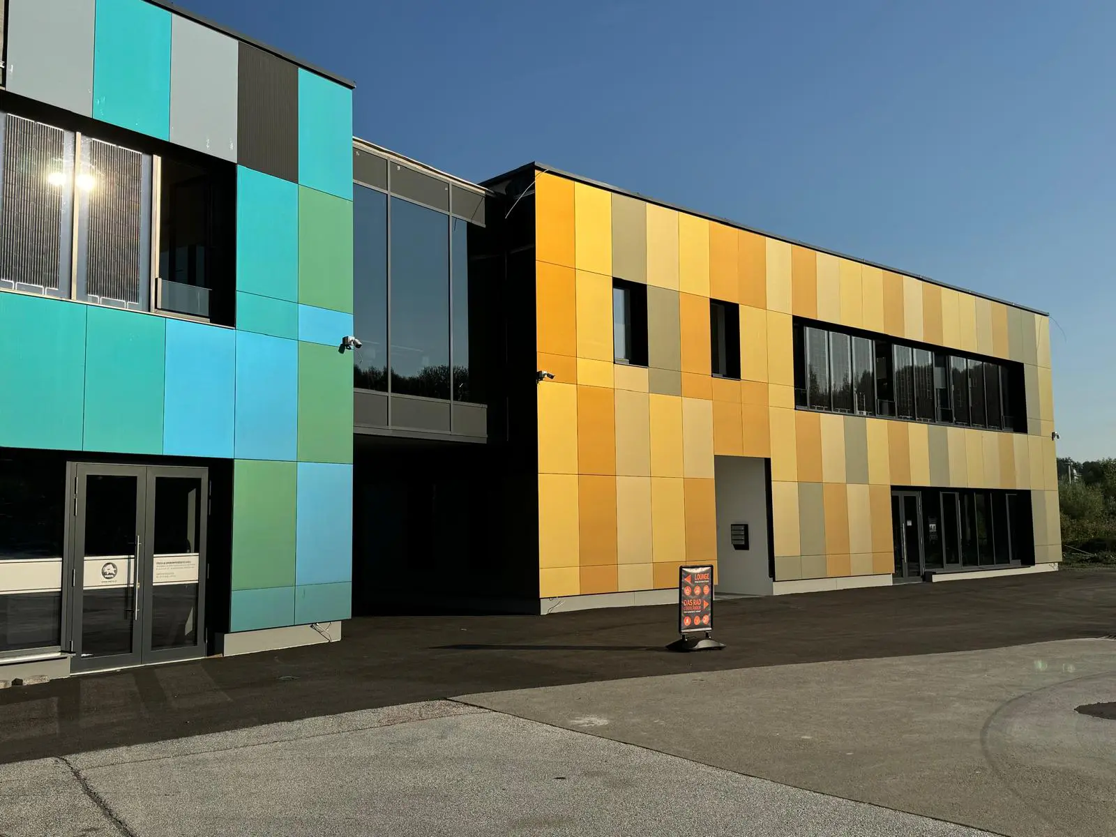 Modern building facade with colorful solar panels.